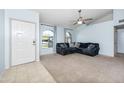 Living room with a sectional sofa and neutral carpeting at 4749 E Evergreen St, Mesa, AZ 85205