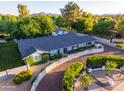 Aerial view of a well-maintained home with mature landscaping, a new roof, and a circular driveway at 5249 E Thunderbird Rd, Scottsdale, AZ 85254