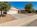 House exterior showcasing a garage and a well-maintained yard at 7420 W Glass Ln, Laveen, AZ 85339