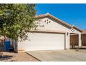 View of the house's garage and a portion of the front yard at 7420 W Glass Ln, Laveen, AZ 85339