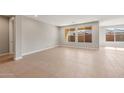 Bright and airy living room with tile floors and large windows at 7659 W Cactus Wren Way, Florence, AZ 85132