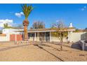 Mid-century home with a landscaped front yard and palm tree at 8019 N 14Th St, Phoenix, AZ 85020