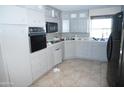 Bright kitchen featuring built-in appliances and tile flooring at 8643 S 16Th Pl, Phoenix, AZ 85042