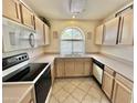 Bright kitchen with white appliances, tile floor and a window over the sink at 9131 W Boca Raton Rd, Peoria, AZ 85381