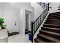 Bright entryway with staircase, tile floor, and modern decor at 9625 E Spiral Ave, Mesa, AZ 85212