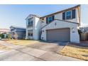 Two-story home with a light-colored exterior, a two-car garage, and a front yard at 9625 E Spiral Ave, Mesa, AZ 85212