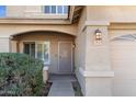 Front entry with a metal security door and mature shrubbery at 11625 W Jackson St, Avondale, AZ 85323