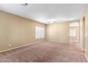 Bright living room featuring neutral walls and carpet at 11625 W Jackson St, Avondale, AZ 85323