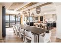 Elegant dining area with a long table and modern lighting fixtures at 13801 N Moon Dr, Phoenix, AZ 85023