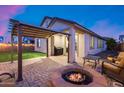 Patio with fire pit, pergola, and artificial turf at 14355 W Desert Hollow Dr, Surprise, AZ 85387