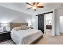 Main bedroom with barn door and ensuite bathroom at 14355 W Desert Hollow Dr, Surprise, AZ 85387