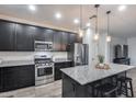 Modern kitchen with stainless steel appliances and island at 14355 W Desert Hollow Dr, Surprise, AZ 85387