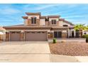 Two-story house with three-car garage, stone accents, and landscaped yard at 1451 E Ivanhoe St, Gilbert, AZ 85295