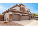 Two-story house with three-car garage, stone accents, and landscaped yard at 1451 E Ivanhoe St, Gilbert, AZ 85295