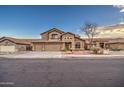 Two-story house with three-car garage and desert landscaping at 15727 W Rimrock St, Surprise, AZ 85374