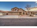 Two-story house with three-car garage and desert landscaping at 15727 W Rimrock St, Surprise, AZ 85374