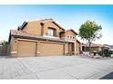 Inviting two-story residence with a spacious three-car garage and beautifully maintained front yard at 15727 W Rimrock St, Surprise, AZ 85374