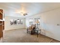 Living room features a comfortable armchair and a ceiling fan at 16230 N 35Th Way, Phoenix, AZ 85032