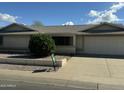 Charming single-story home featuring a well-maintained front yard and a two-car garage at 17407 N Country Club N Dr, Sun City, AZ 85373