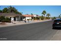 Residential street with single-Gathering homes and palm trees at 17407 N Country Club N Dr, Sun City, AZ 85373