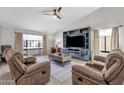 Living room with two sofas, coffee table, and built-in entertainment center at 17600 N 64Th Dr, Glendale, AZ 85308