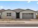 Charming single-story home with gray exterior, a tile roof, and a two-car garage at 17679 W Southgate Ave, Goodyear, AZ 85338