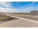 Landscaped front yard with paver driveway and desert plants at 18897 N 264Th Ln, Buckeye, AZ 85396