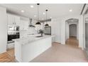 Modern kitchen with white cabinets, quartz counters, and island at 18897 N 264Th Ln, Buckeye, AZ 85396