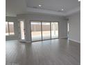 Bright and airy living room featuring tile floors and large sliding glass doors leading to the patio at 20233 W San Miguel Ave, Litchfield Park, AZ 85340