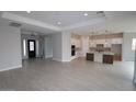 Spacious living room with tile floors, recessed lights, and an open floor plan to the kitchen at 20233 W San Miguel Ave, Litchfield Park, AZ 85340