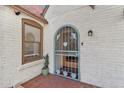 Welcoming front entrance with decorative door, brick accents, and charming details at 2209 E Weldon Ave, Phoenix, AZ 85016