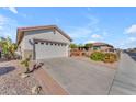 Two-car garage with driveway and desert landscaping at 22992 W Lasso Ln, Buckeye, AZ 85326