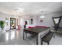 Stylish game room with pool table and modern light fixtures at 26846 N 73Rd St, Scottsdale, AZ 85266