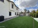 Artificial turf backyard with patio furniture and a hammock at 2715 S Sailors Way, Gilbert, AZ 85295