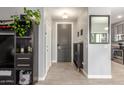 Bright entryway with dark gray door, wood-look tile floor, and built-in shelving at 2715 S Sailors Way, Gilbert, AZ 85295