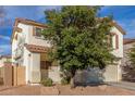 Two-story house with beige exterior, brown shutters, and a two-car garage at 2715 S Sailors Way, Gilbert, AZ 85295