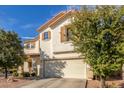 Two-story house with beige exterior, brown shutters, and a two-car garage at 2715 S Sailors Way, Gilbert, AZ 85295