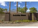 Dobbin's Manor community entrance with signage and landscaping at 3041 W La Mirada Dr, Laveen, AZ 85339