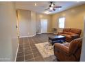 Living room with two brown leather recliners and a coffee table at 35706 W Costa Blanca Dr, Maricopa, AZ 85138