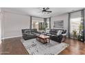 This living room has wood floors, curtains, and ample space for comfortable seating at 3711 E Sandy Way, Gilbert, AZ 85297