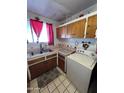 Galley style kitchen with wood cabinets and a double sink at 4402 W Verde Ln, Phoenix, AZ 85031