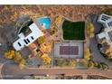 Bird's eye view of a home, pool, tennis court and landscape at 5113 W Arrowhead Lakes Dr, Glendale, AZ 85308