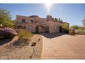 Spanish style home with gated entrance and brick driveway at 5113 W Arrowhead Lakes Dr, Glendale, AZ 85308