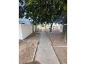 Shared walkway between condo units, shaded by large trees at 5233 N 42Nd Dr, Phoenix, AZ 85019