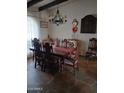 Dining room with a large table, ornate chairs, chandelier, and decorative wall art at 6124 N 130Th Ave, Litchfield Park, AZ 85340