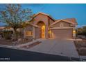 Evening view of a lovely one-story home with a welcoming front entrance at 6043 S Fairway Dr, Gold Canyon, AZ 85118