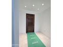 Elegant entryway with dark wood door and marble flooring at 6587 N Palmeraie Blvd # 2010, Paradise Valley, AZ 85253