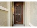 Ornate brown metal front door with sun design and western accents at 7225 W Jones Ave, Phoenix, AZ 85043