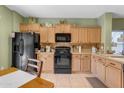 Well-equipped kitchen with light wood cabinets and black appliances at 7325 W Pleasant Oak Way, Florence, AZ 85132