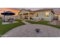 Artificial turf backyard with covered patio and fire pit at 7332 S Briarwood Ln, Gilbert, AZ 85298